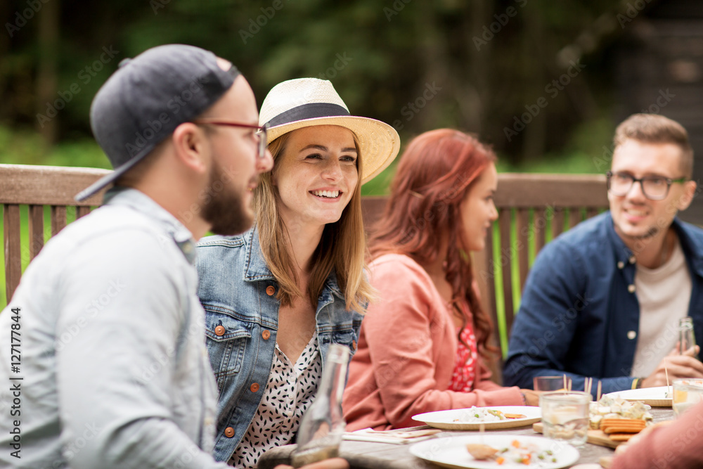happy friends having dinner at summer garden party happy friends having dinner at summer garden party