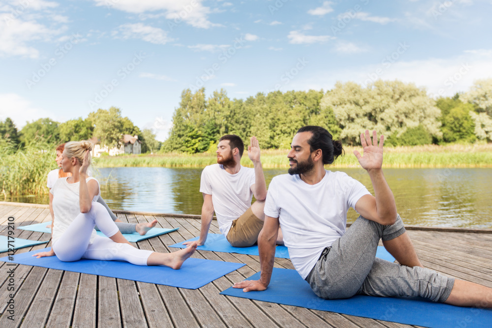 people making yoga in half lord of the fishes pose people making yoga in half lord of the fishes pose