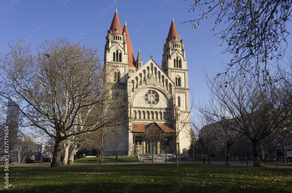 St.Francis of Assisi church and its park in Vienna in winter season, with bare trees