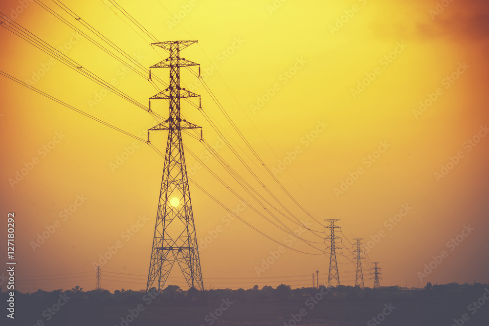 Electric high voltage power in the field with sunset background.Vintage or retro tone