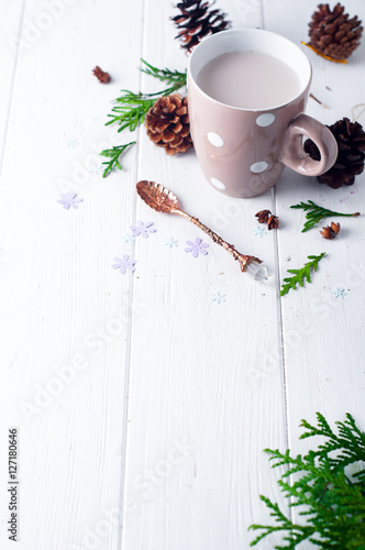 vintage Cup of hot cocoa on wooden background decorated with spruce and pine cones,