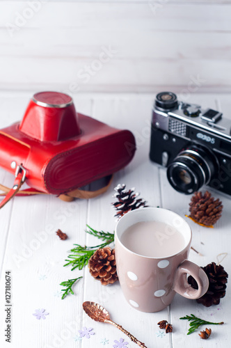 vintage Cup of hot cocoa on wooden background decorated with spruce and pine cones 