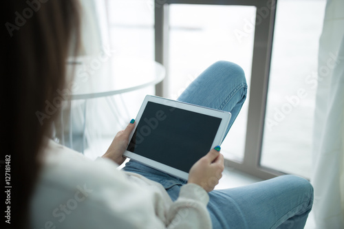 Vászonkép Using a tablet PC touchpad in a room