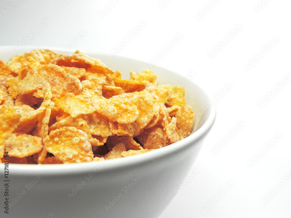 cornflakes in a white bowl, isolated on white background. cornflakes in a white bowl, isolated on white background.