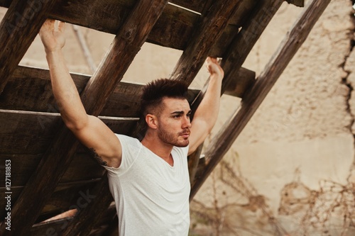 Attractive guy with white t-shirt in a old house