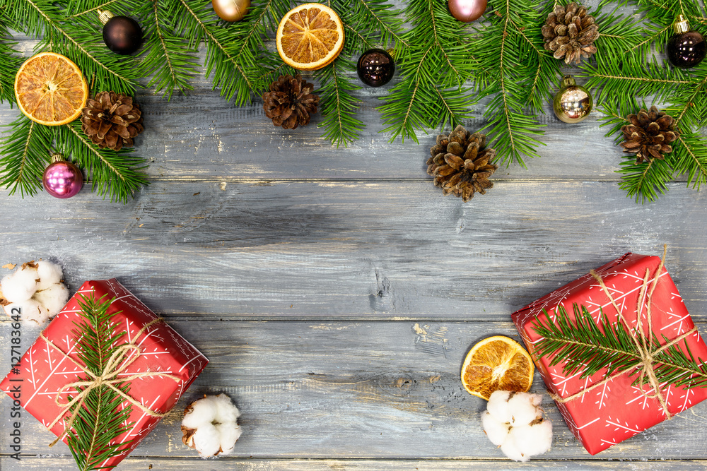 Christmas background with decorations and gift boxes on wooden board