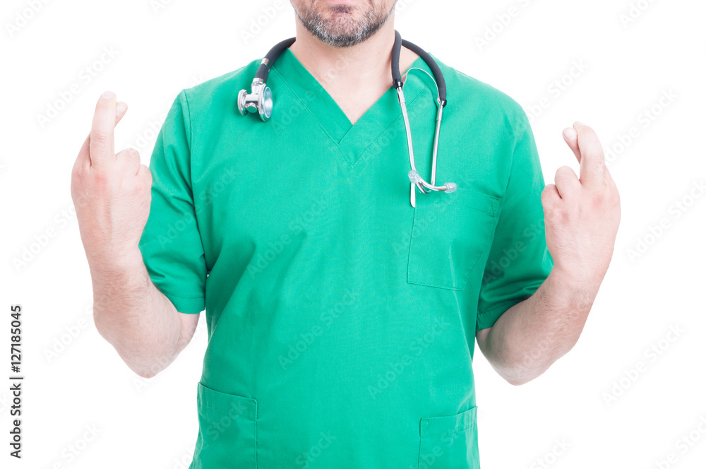 Male doctor making crossing fingers gesture Male doctor making crossing fingers gesture