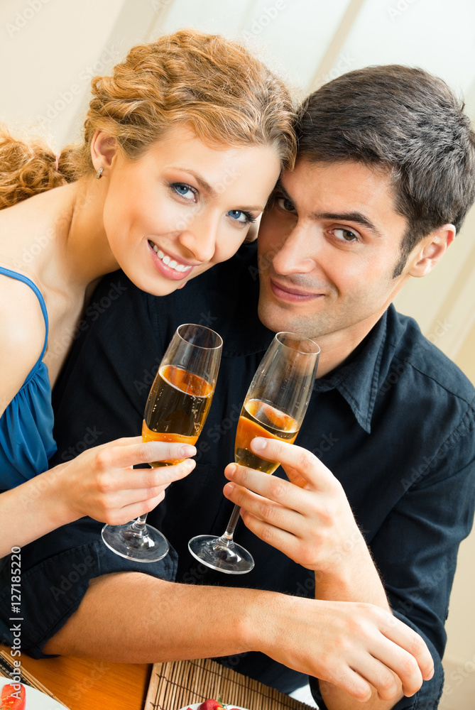 Young couple celebrating with champagne at home. Love, relations, romantic concept shoot. Young couple celebrating with champagne at home. Love, relations, romantic concept shoot.