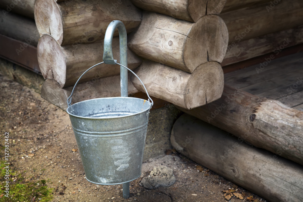 Iron bucket on a hook at a timbered felling. Iron bucket on a hook at a timbered felling.