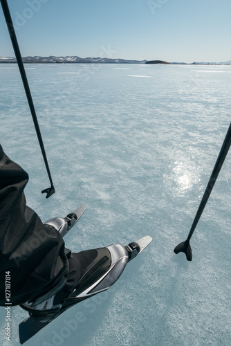 Tourists travel to Norway hiking ice skating on the frozen lake. Special long skate for long distances. Mounting under the ski boots. Location of Lake Baikal action. The Russian called Bayes or Loft. photo