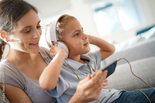 Mother and son listening to music with smartphone photo