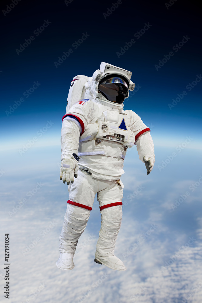 Fototapeta premium astronaut wearing pressure suit in a space background