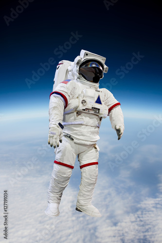 Fototapeta Naklejka Na Ścianę i Meble -  astronaut wearing pressure suit in a space background