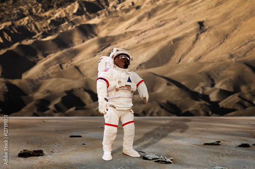 Fototapeta Naklejka Na Ścianę i Meble -  astronaut wearing pressure suit in a sand dune background