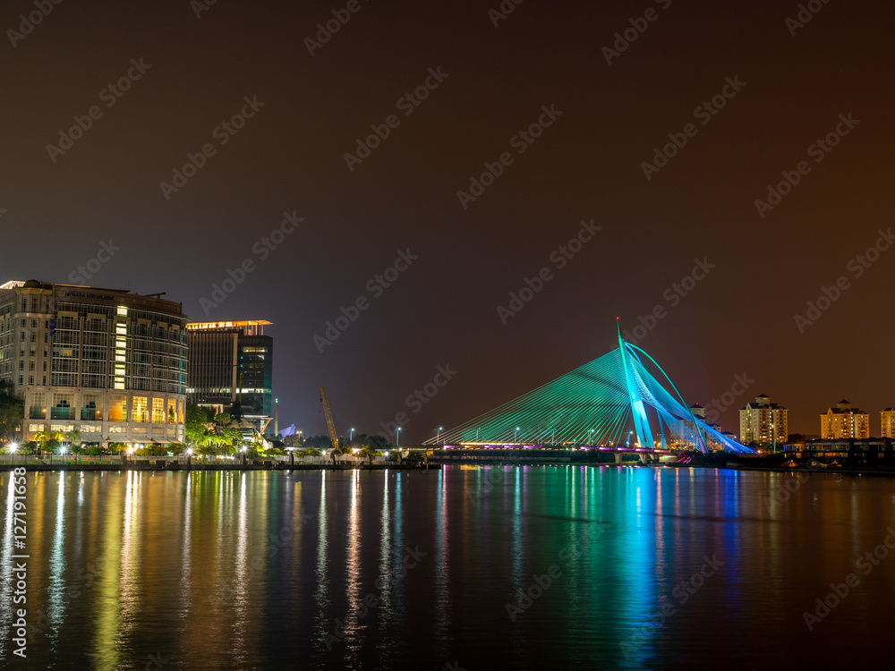 Green colour lighted Seri Wawasan Bridge with reflection on the water at Putrajaya, Malaysia