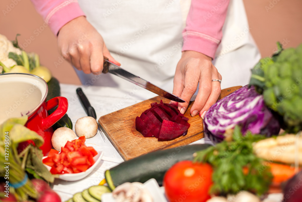 Cutting of beetroot with a knife, vegetable cutting in the kitch Cutting of beetroot with a knife, vegetable cutting in the kitch