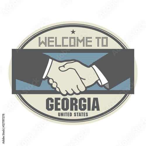 Business concept with handshake and the text Welcome to Georgia,