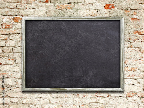 Bild auf Leinwand Single blank blackboard frame on weathered brick wall background