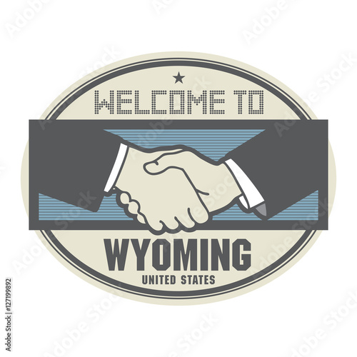 Business concept with handshake and the text Welcome to Wyoming,