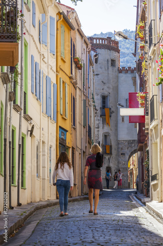 Two women walking towards the old town, Ceret, Vallespir region, Pyrenees, France