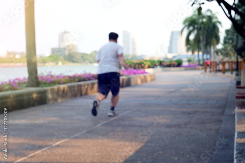 Blurred or De-focus man jogging in the park with gradient effect,Fitness concept. © abimagestudio