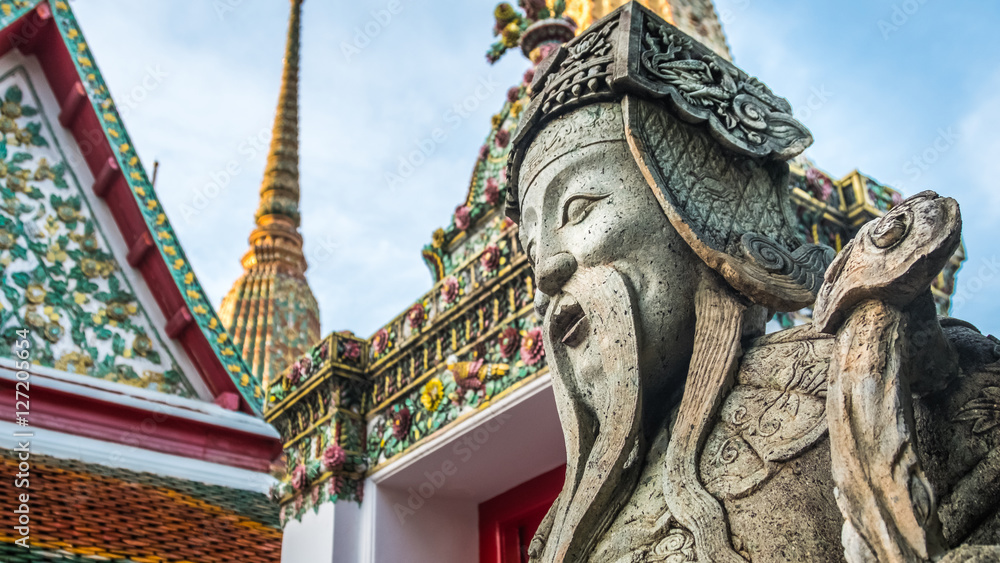 Fototapeta premium Stone Thai-Chinese style sculpture and thai art architecture in Wat Phra Chetupon Vimolmangklararm (Wat Pho) temple, Thailand. Photo taken on: 2 November , 2016