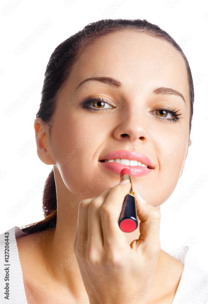 portrait of young woman applying lipstick, isolated portrait of young woman applying lipstick, isolated