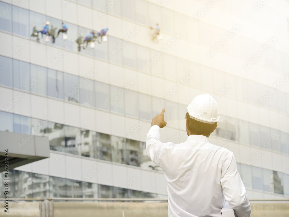 Female and male engineers with Workers washing windows in the of Female and male engineers with Workers washing windows in the of