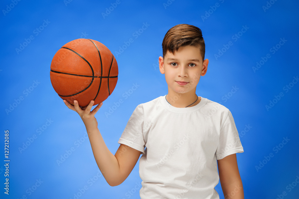 Adorable 11 year old boy child with basketball ball