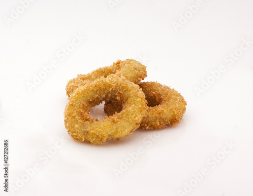 fried onion rings in dough sprinkled with crumbs on a white background