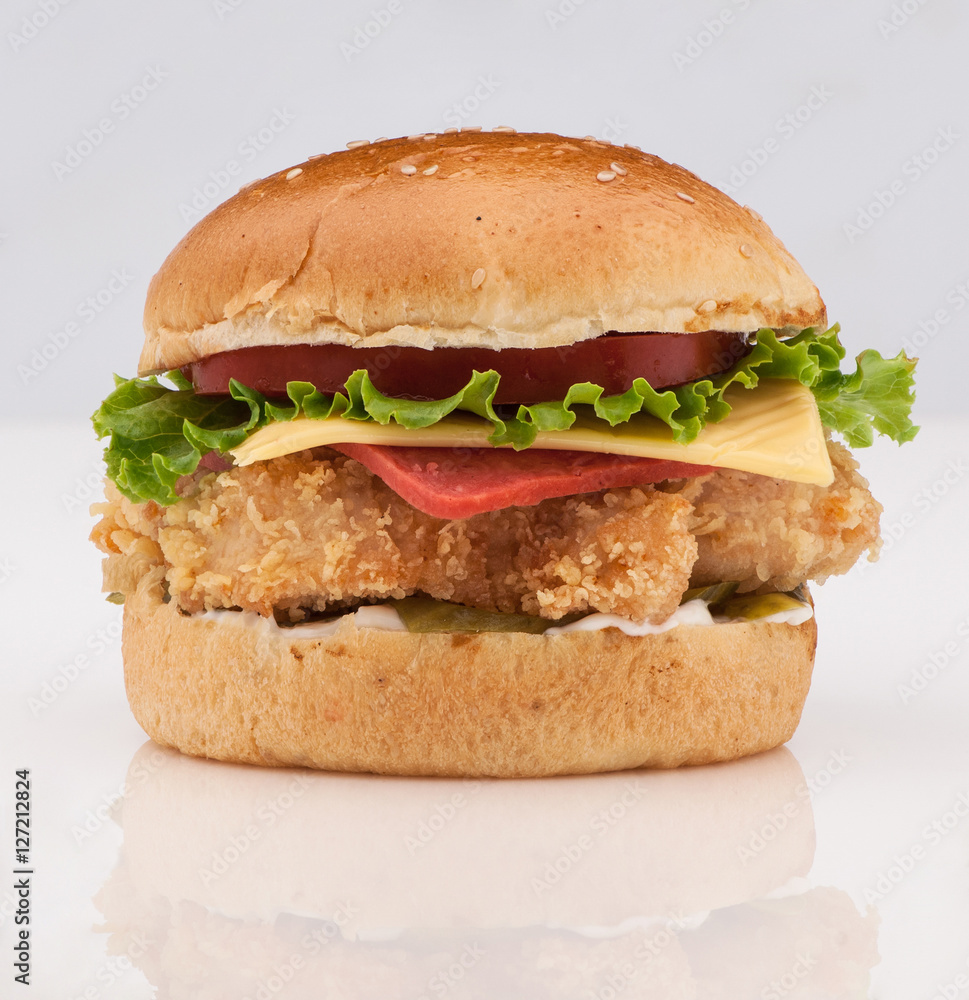 cheeseburger with a chicken on a white background with reflection closeup cheeseburger with a chicken on a white background with reflection closeup