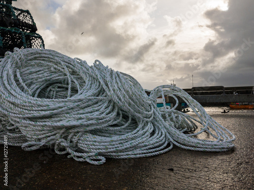 BRIDLINGTON, ENGLAND - NOVEMBER 6: Fresh, new white rope coiled in Bridlington harbour. In Bridlington, East Yorkshire, England. On 6th November 2016.