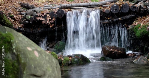 a Small Waterfall in the Mountains Autumn Forest With Yellow Foliage and Mossy Rocks