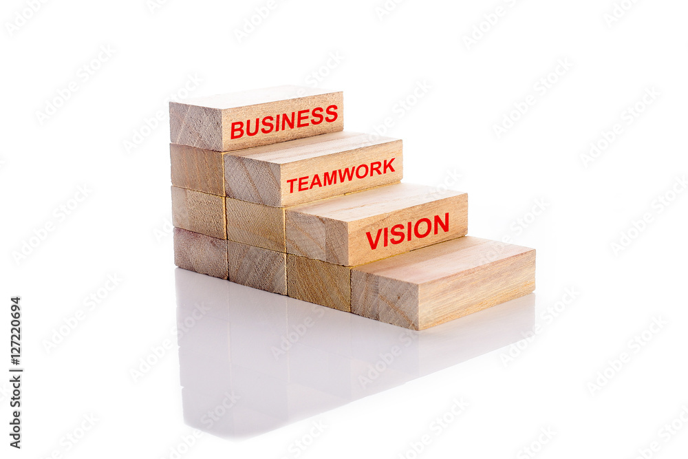 Business, teamwork, vision word on wooden cubes stack. Step to success in business concept Business, teamwork, vision word on wooden cubes stack. Step to success in business concept