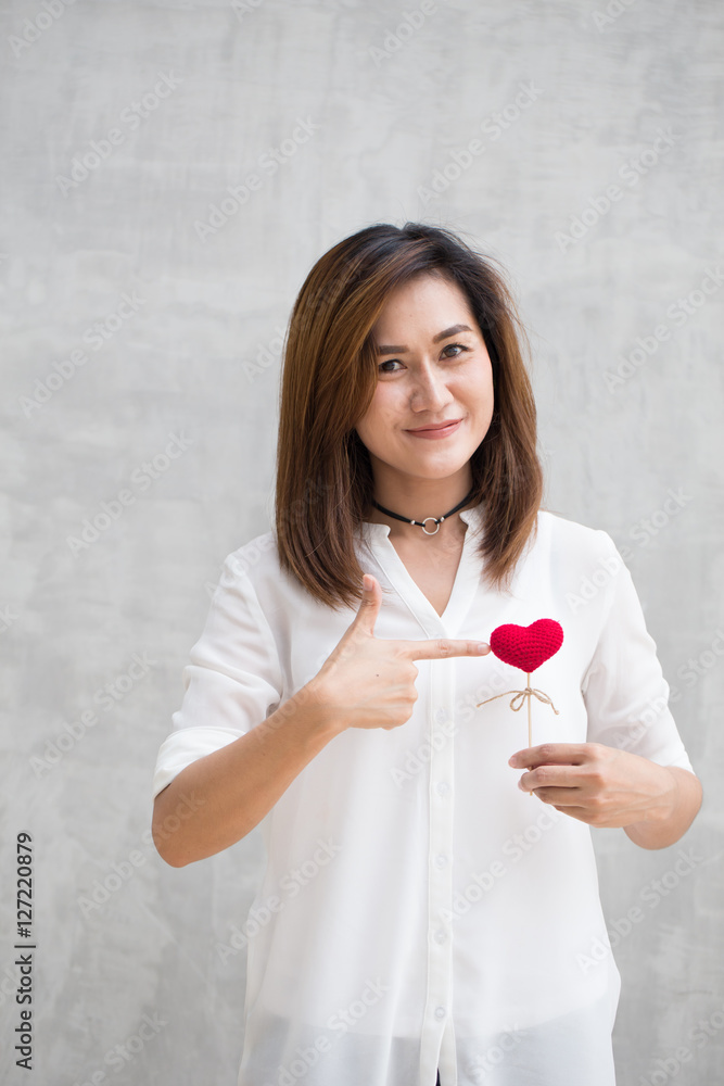 Take care your heart healthy concept, Asian woman hand hold red heart yarn and point her finger to. Take care your heart healthy concept, Asian woman hand hold red heart yarn and point her finger to.