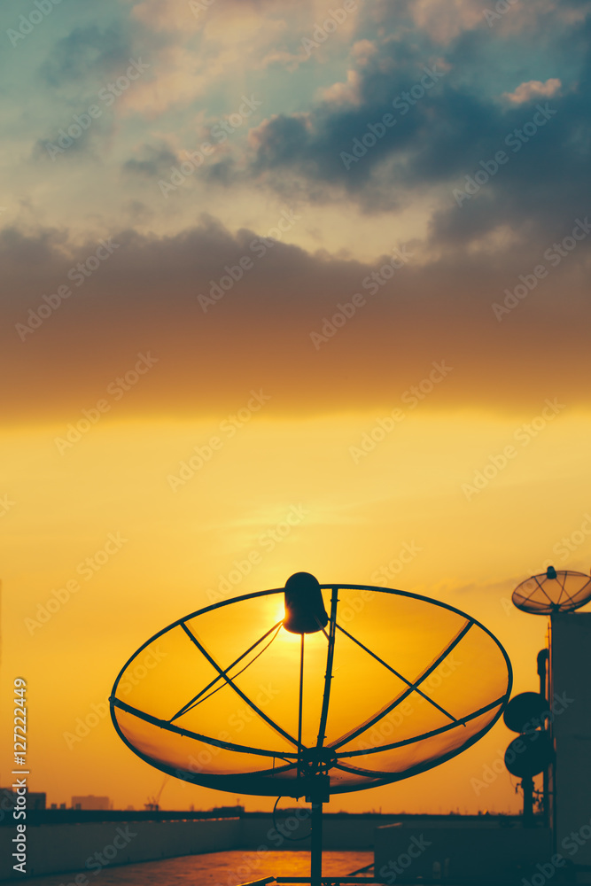 satellite dish in golden sunset sky background.