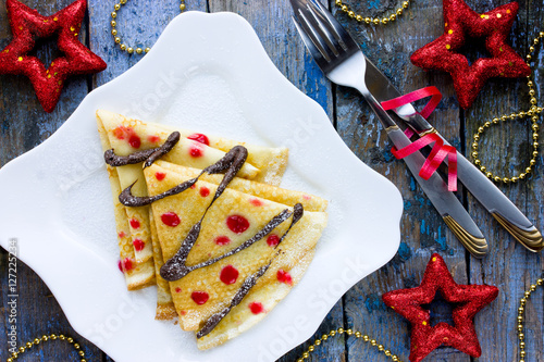 Delicious breakfast crepes shaped Christmas tree with chocolate