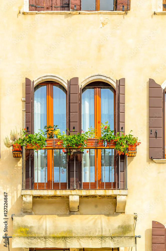 Beautiful window decorated with flowers in italy
