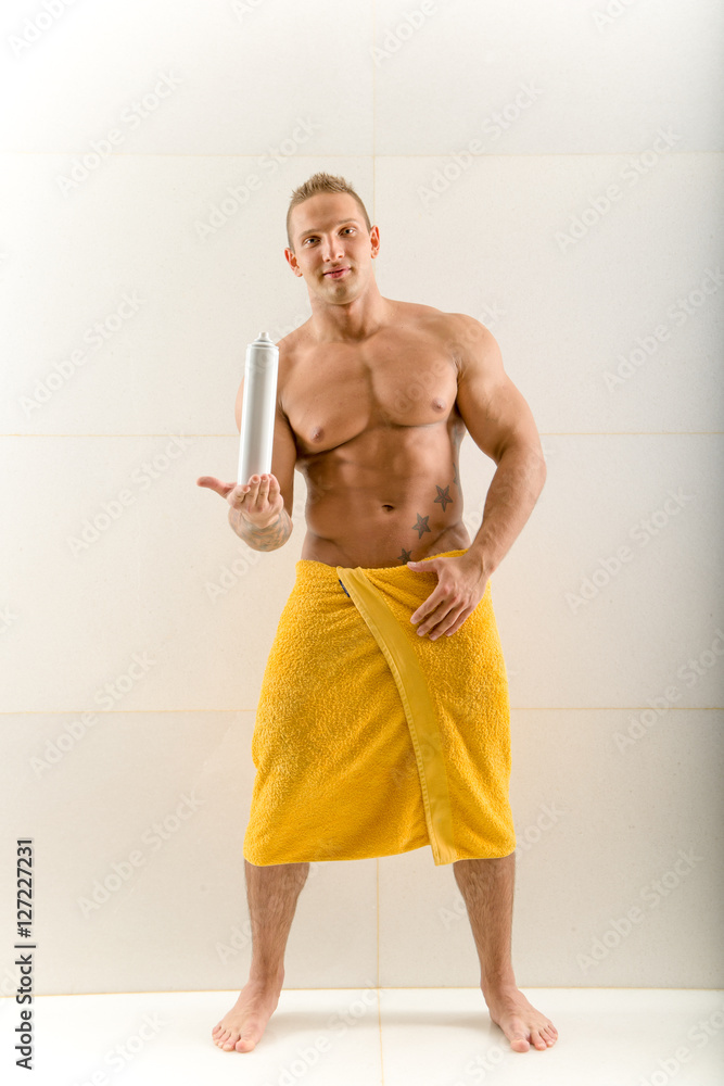 Man spraying deodorant under his arm Man spraying deodorant under his arm