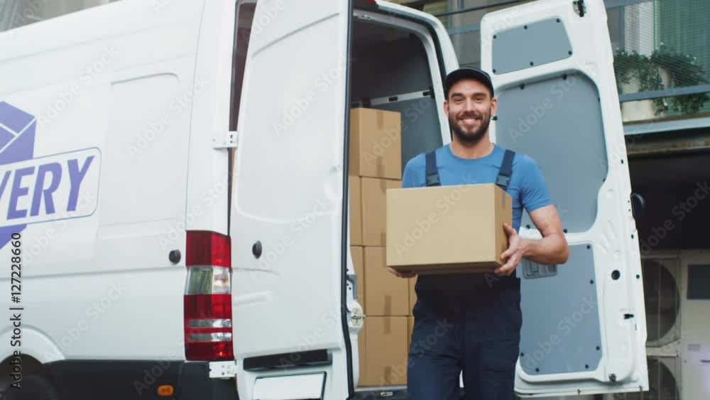 Young and Smiling Delivery Service Man Takes Cardboard Box from his Cargo Van and Walks towards Delivery Destination. Shot on RED Cinema Camera in 4K (UHD). Young and Smiling Delivery Service Man Takes Cardboard Box from his Cargo Van and Walks towards Delivery Destination. Shot on RED Cinema Camera in 4K (UHD).