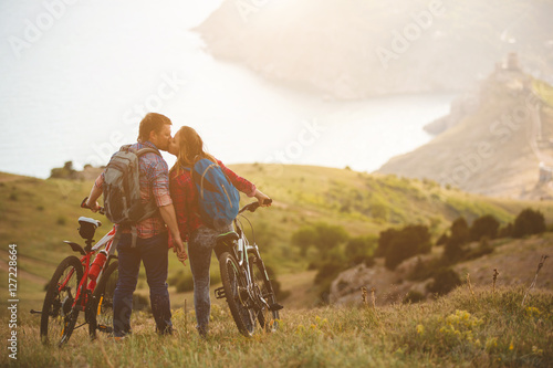 young couple riding bikes in the mountains