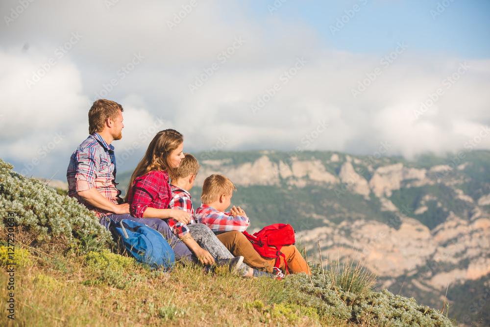 Family of four people looking to beautiful seascape in mountains Family of four people looking to beautiful seascape in mountains