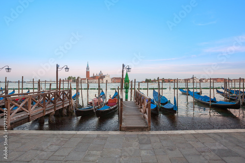 Gondolas moored by Saint Mark square with San Giorgio di Maggiore church in the background - Venice, Venezia, Italy. © Sodel Vladyslav