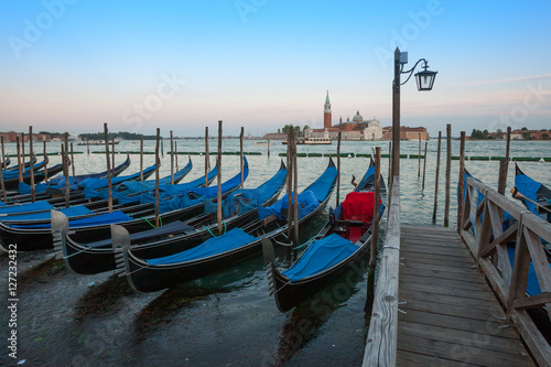 Gondolas moored by Saint Mark square with San Giorgio di Maggiore church in the background - Venice, Venezia, Italy. © Sodel Vladyslav