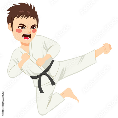 Young teenager black belt karate boy doing kick jump