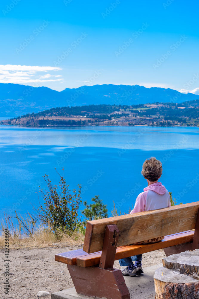 Female tourist at the bench over fantastic lake view in Canada. Female tourist at the bench over fantastic lake view in Canada.