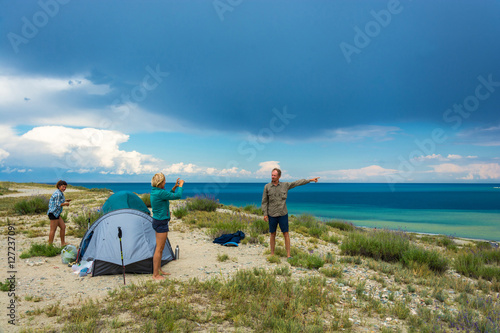 Tourists on the shore of lake Issyk-Kul, Kyrgyzstan.