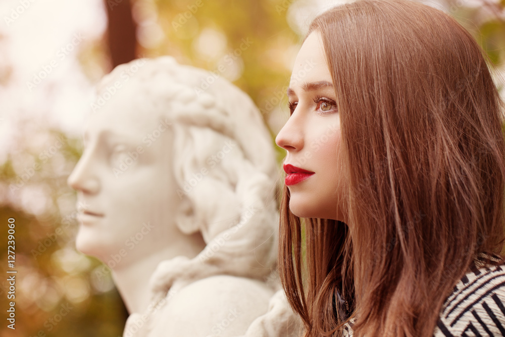 Autumn Portrait of Pretty Woman and Marble Statue Outdoors. Prof Autumn Portrait of Pretty Woman and Marble Statue Outdoors. Prof