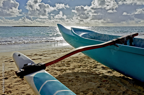 Outrigger canoe on sandy beach in Hawaii at sunrise closeup