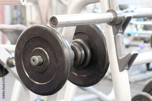 The image of dumbbells in a fitness hall